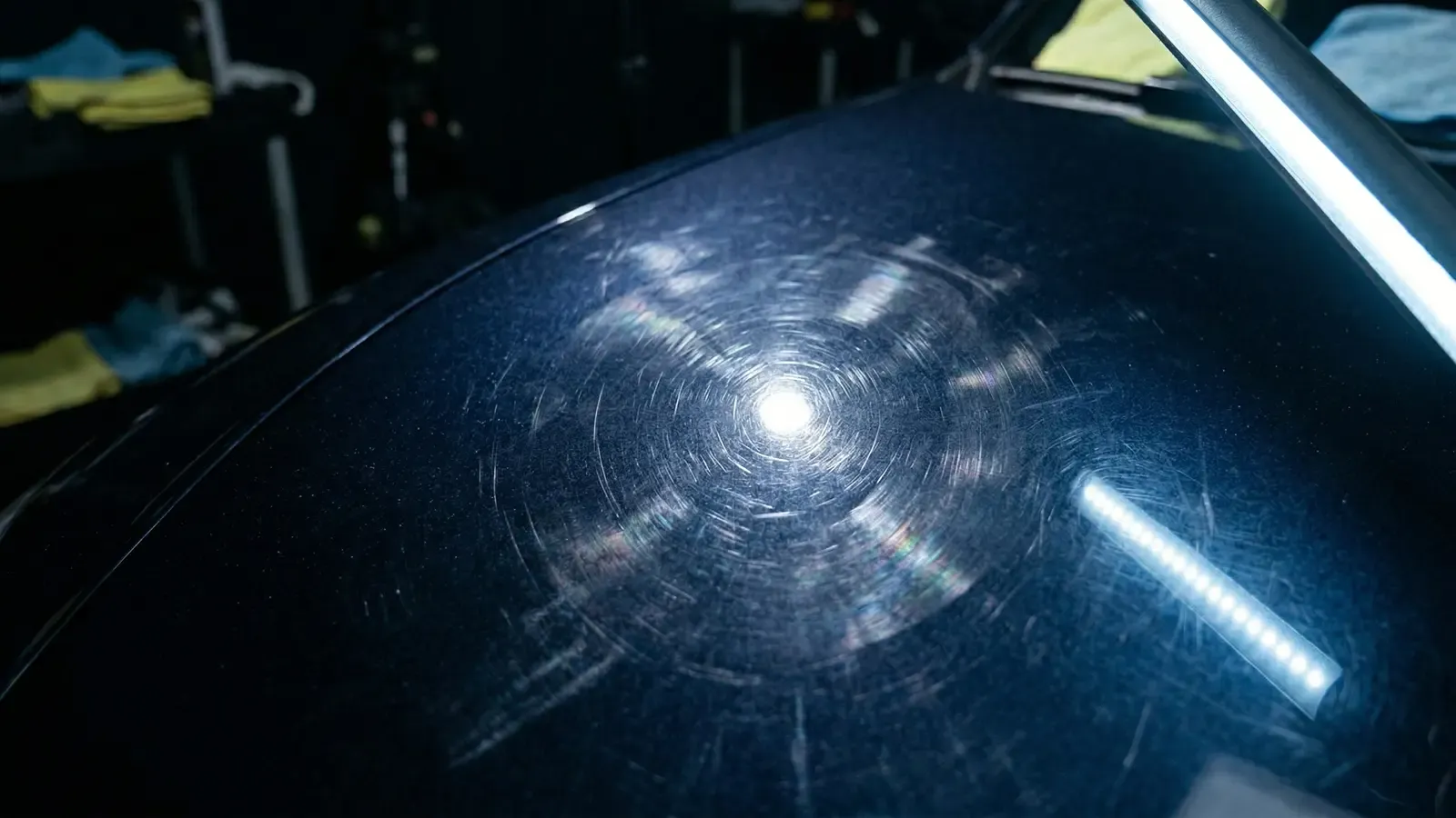 Paint surface showing swirl marks under inspection light before correction